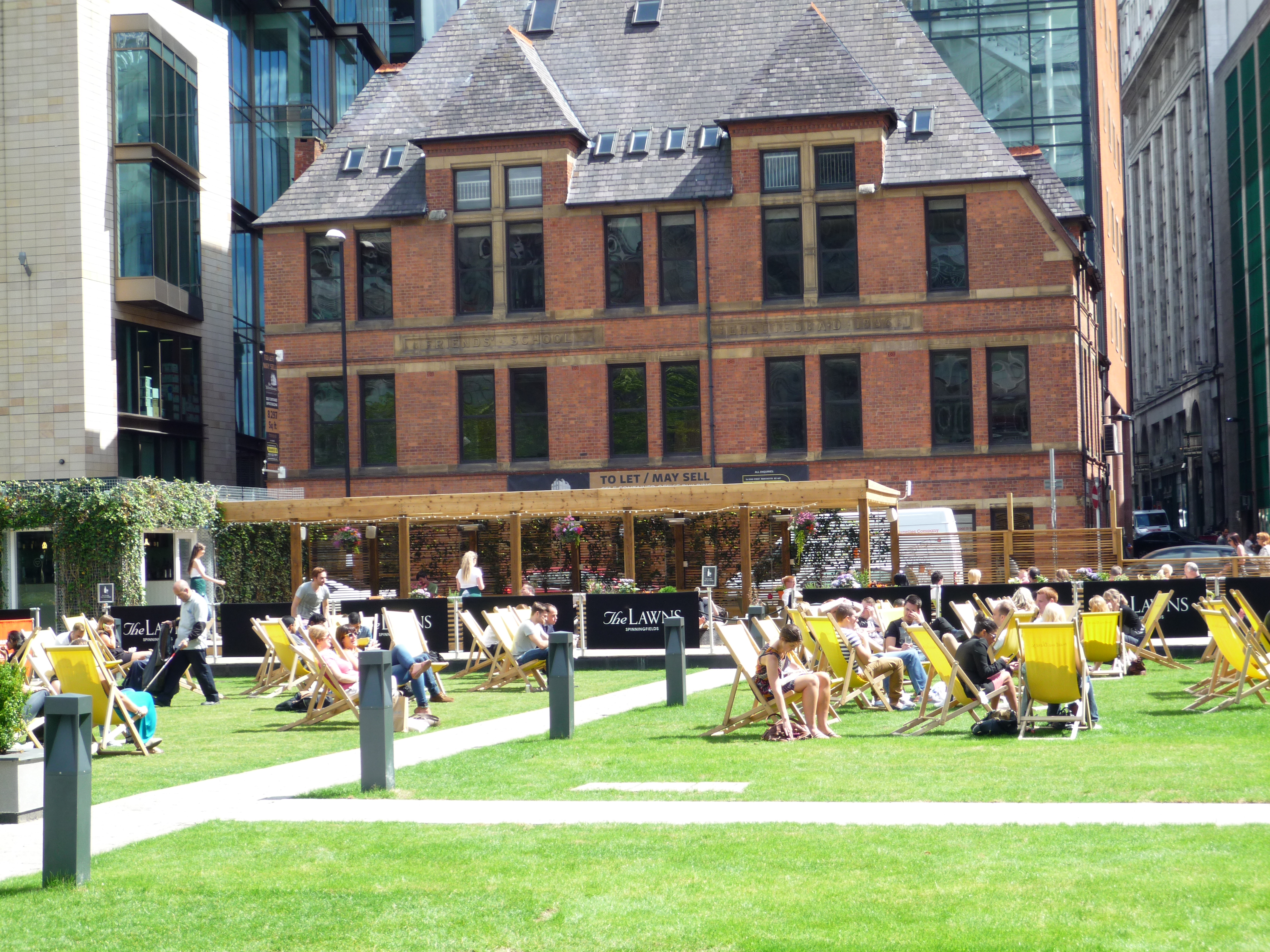 The public enjoy the sun at Spinning Fields square